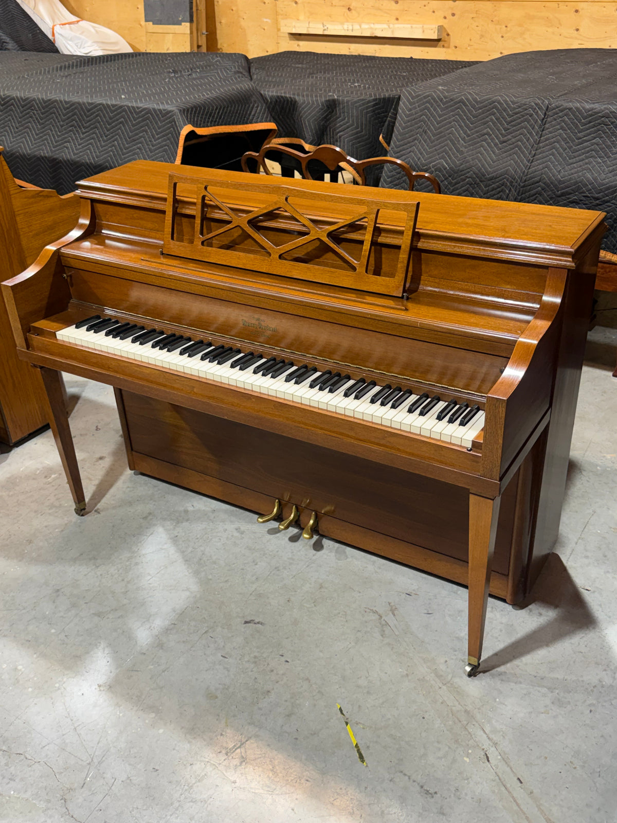 Used Mason & Risch console piano with tapered legs and music desk