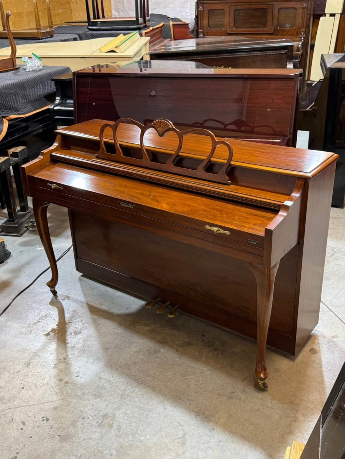 Baldwin Classic console piano with carved shell music desk