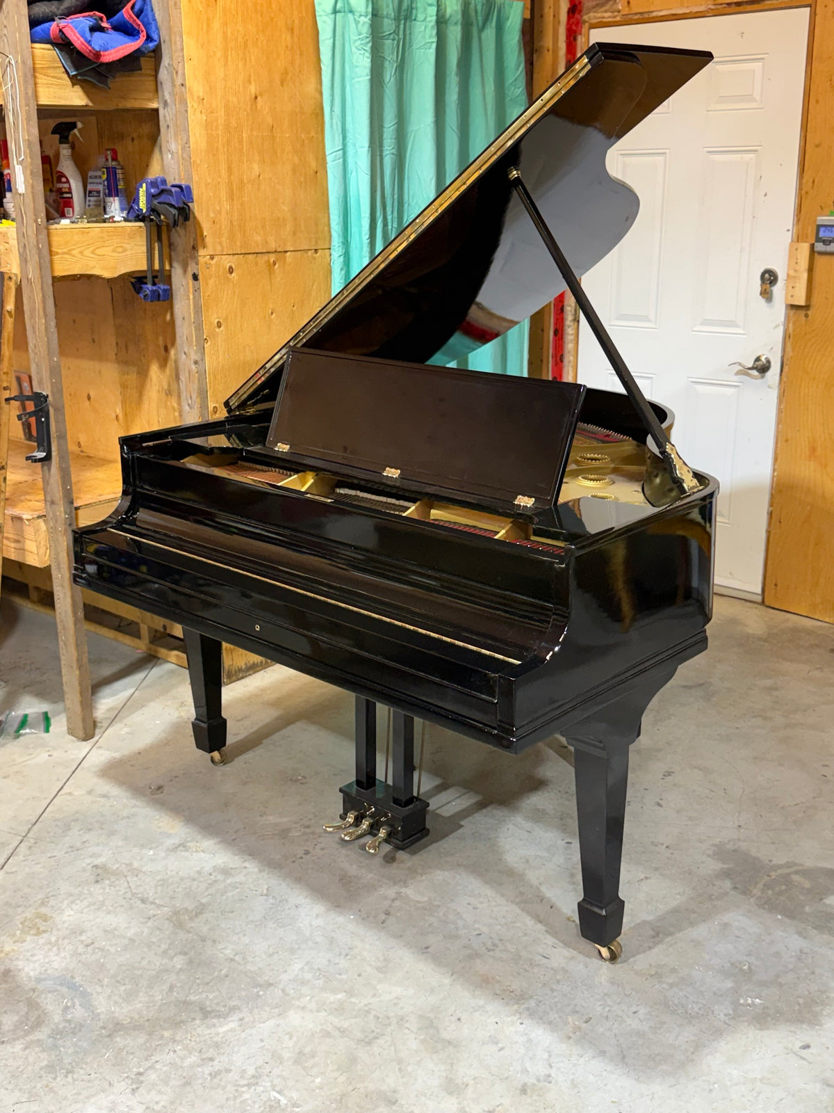 Baldwin grand piano with lid open, fallboard closed