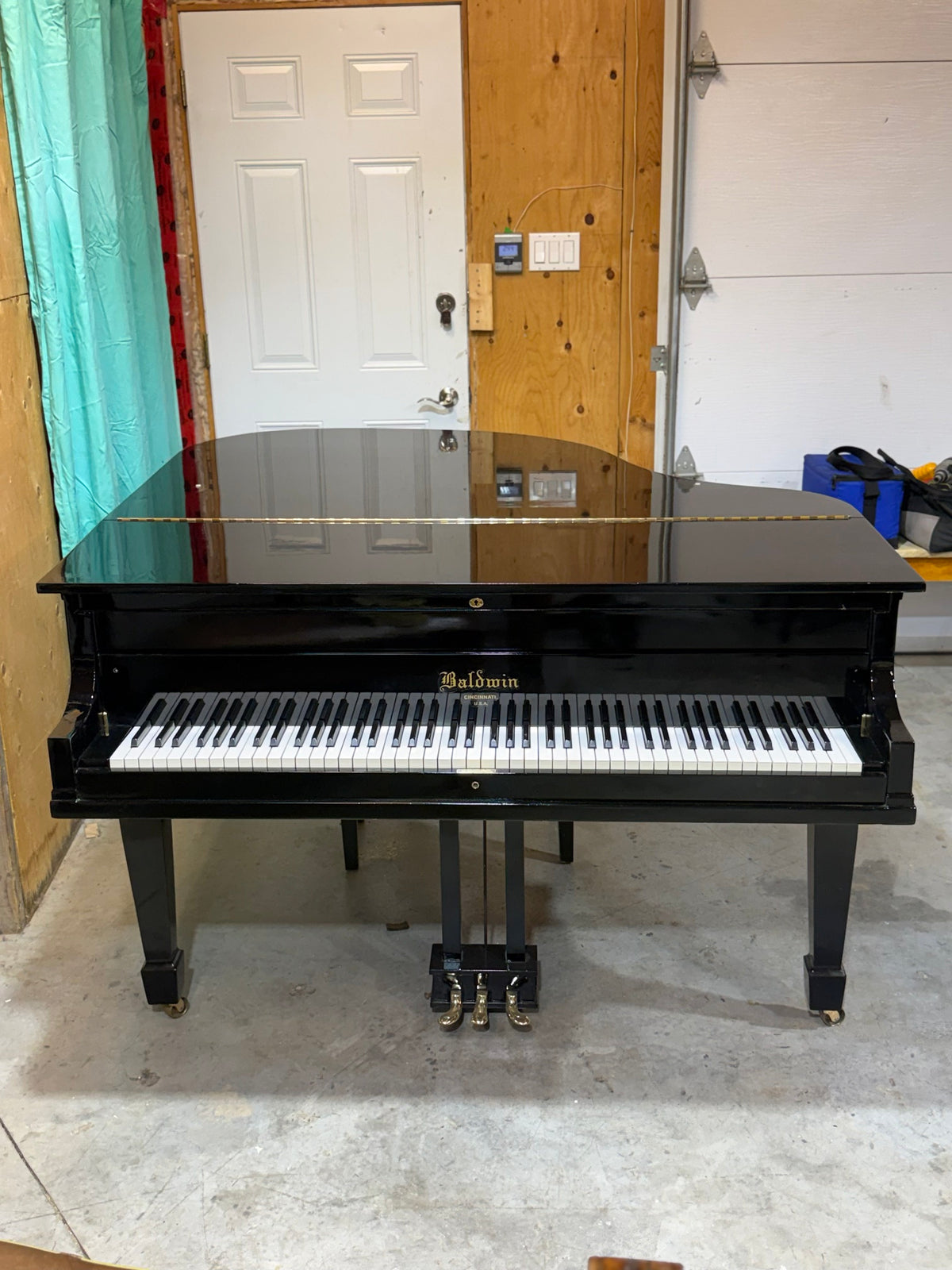 Baldwin grand piano front view, lid closed