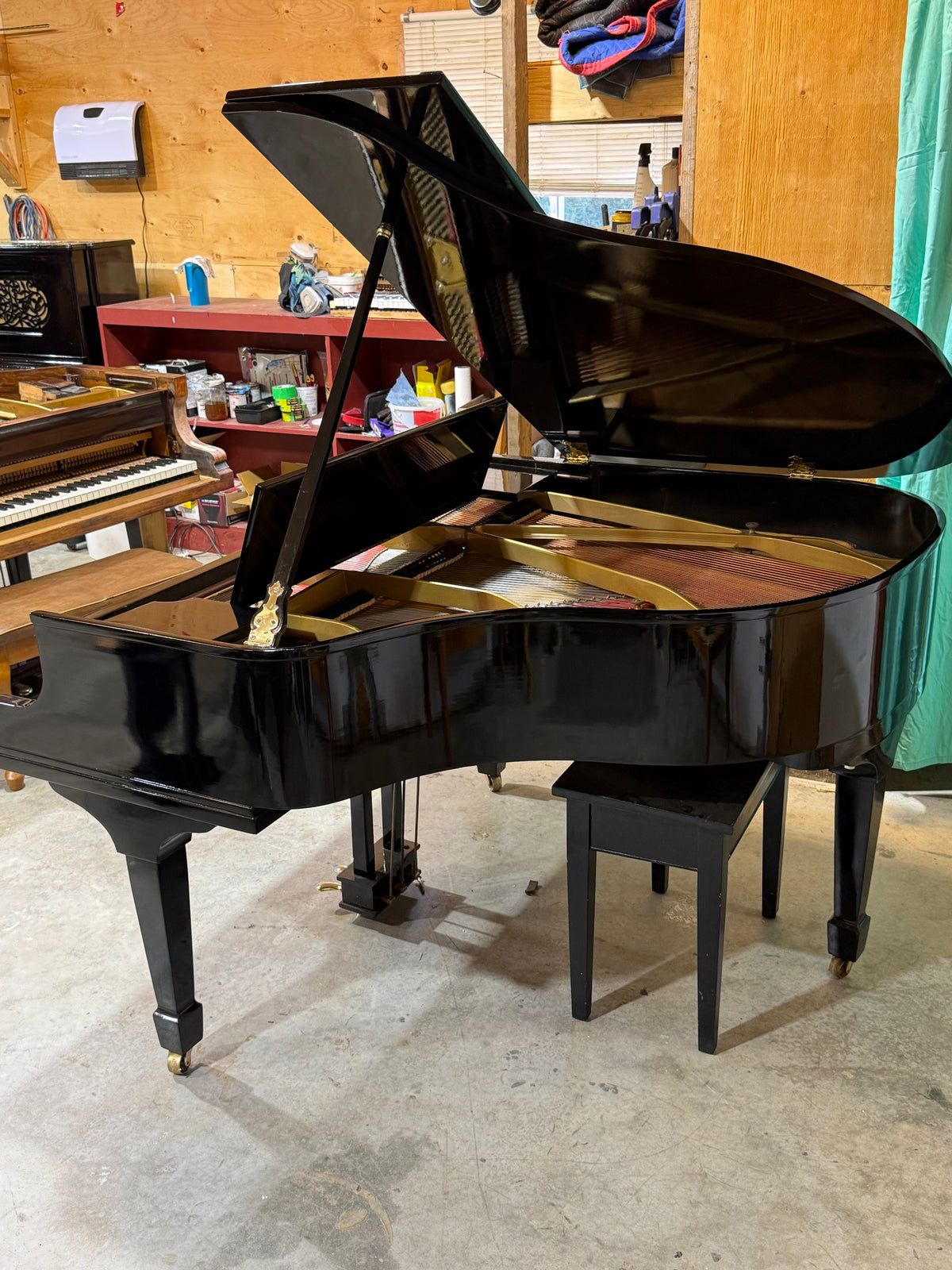 Baldwin grand piano side view with bench