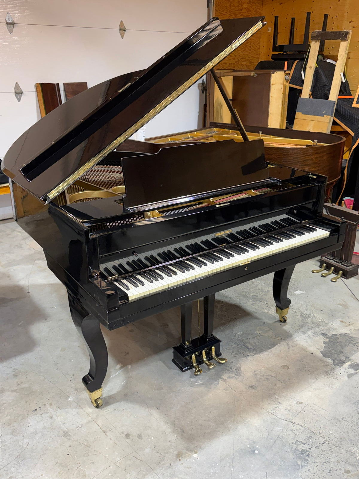 Cunningham Piano Co. grand piano in polished ebony with curved legs