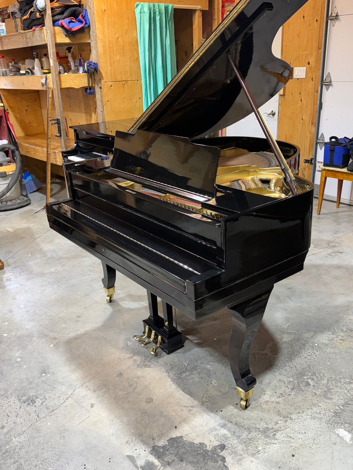 Used Cunningham grand piano, side view with lid open