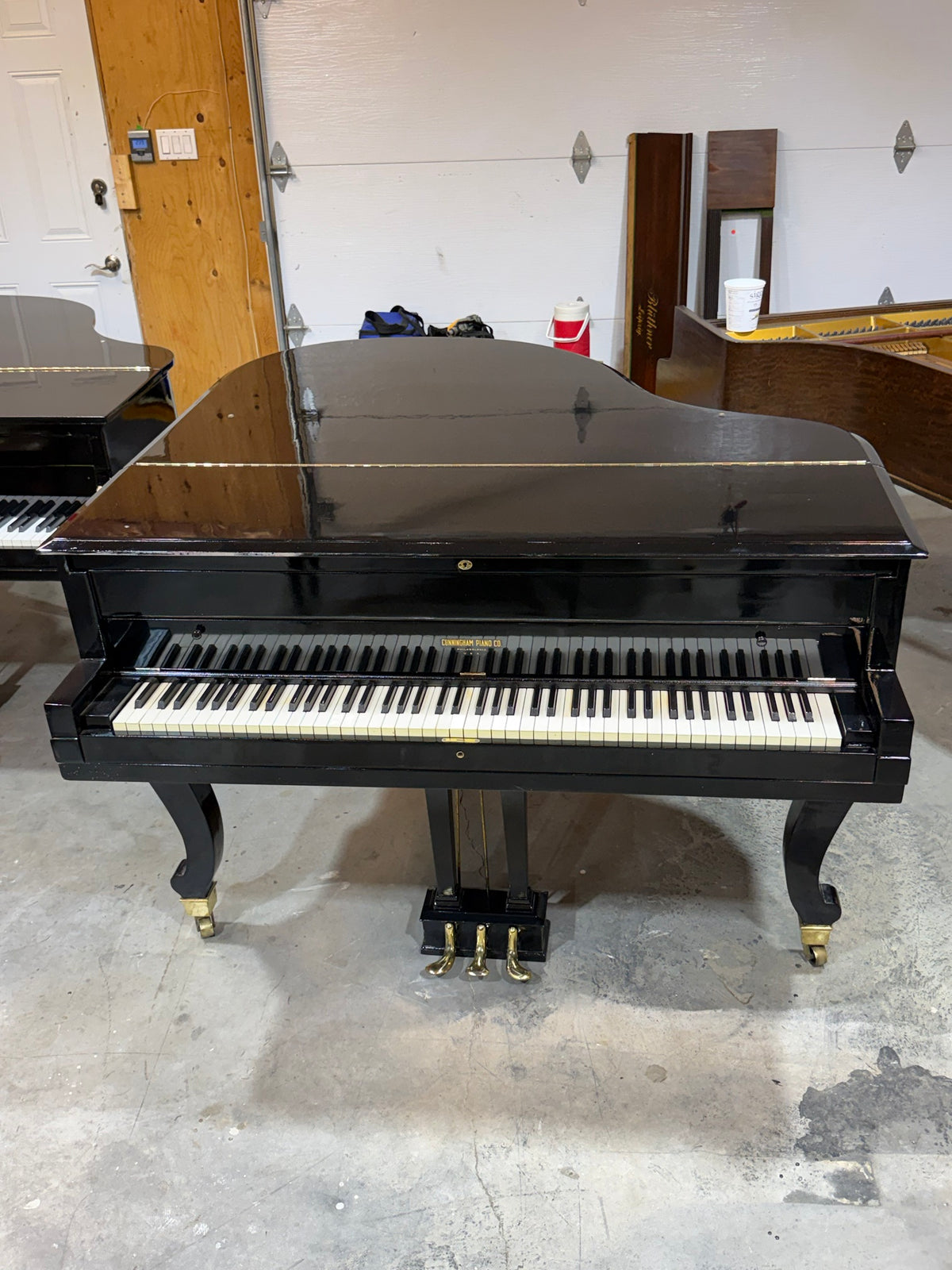 Cunningham grand piano front view, closed