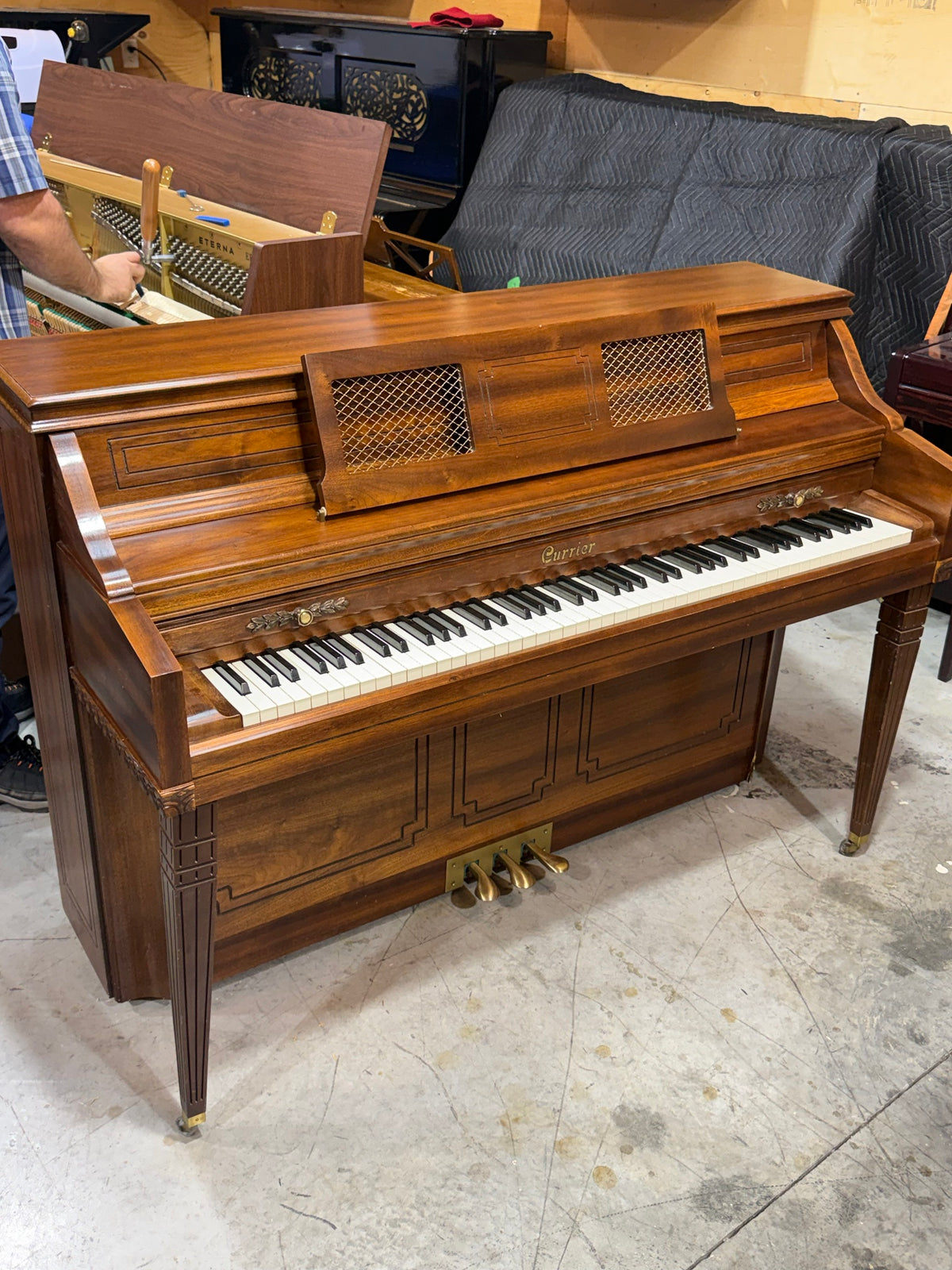Currier console piano keyboard and decorative music desk