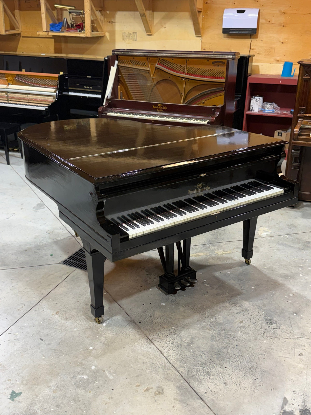 Black Heintzman grand piano with spade legs