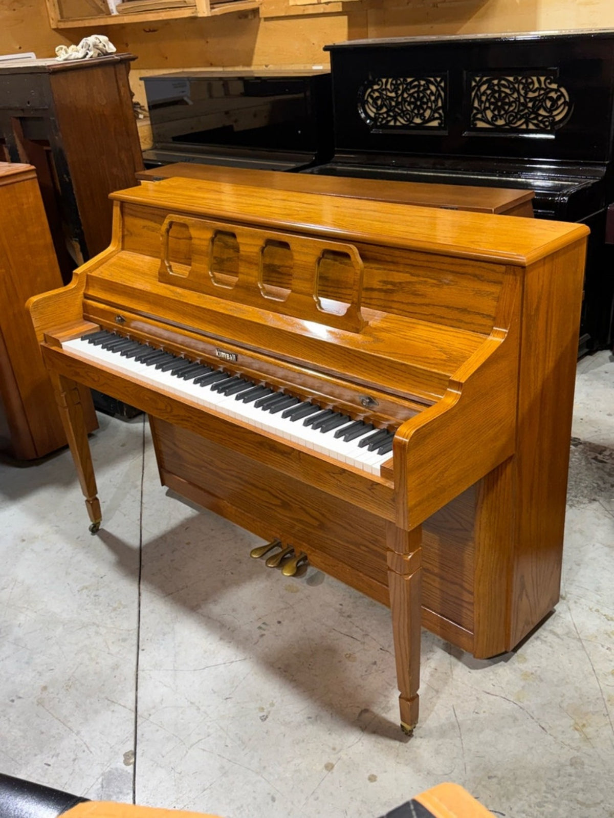 Used Kimball oak console piano side view