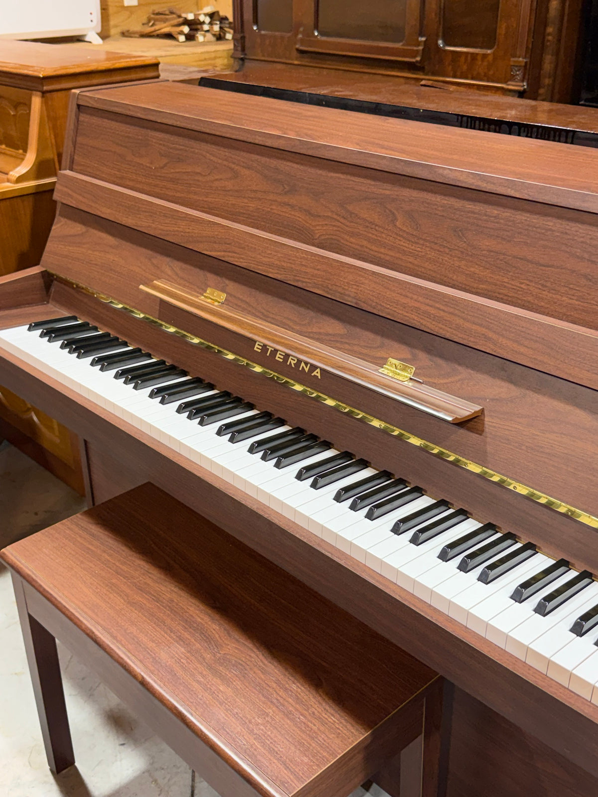 Eterna piano keyboard with music rest and bench