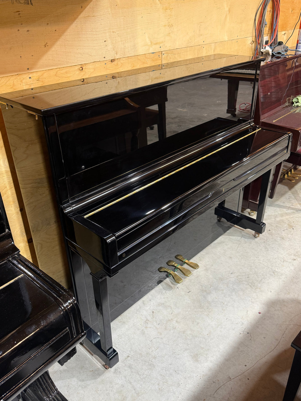 Young Chang black upright piano side view
